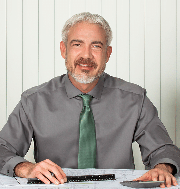 mike-halfbody-blueprint-builder Mike at his desk, working on a blueprint
